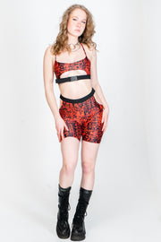 Bright red and black rave shorts with hip cutouts.