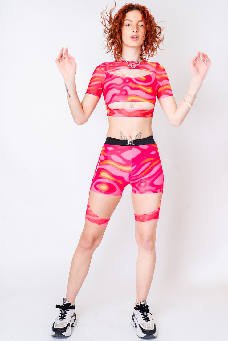 Neon pink and orange layered top with cutouts.