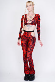 Red and black flared leggings with a hip cutout.