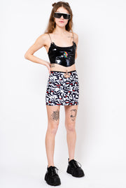 Tribal print skirt with keyhole cutout and chain belt.