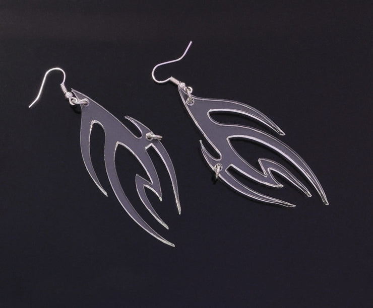 Clear PVC earrings in a flame form with a silver ring piercing.