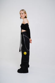 Black wide cut trousers with chain detail.