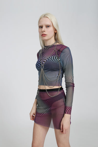 Side view of the abstract purple, blue, pink, and black mesh fabric showing the sheer texture and vibrant trippy pattern.