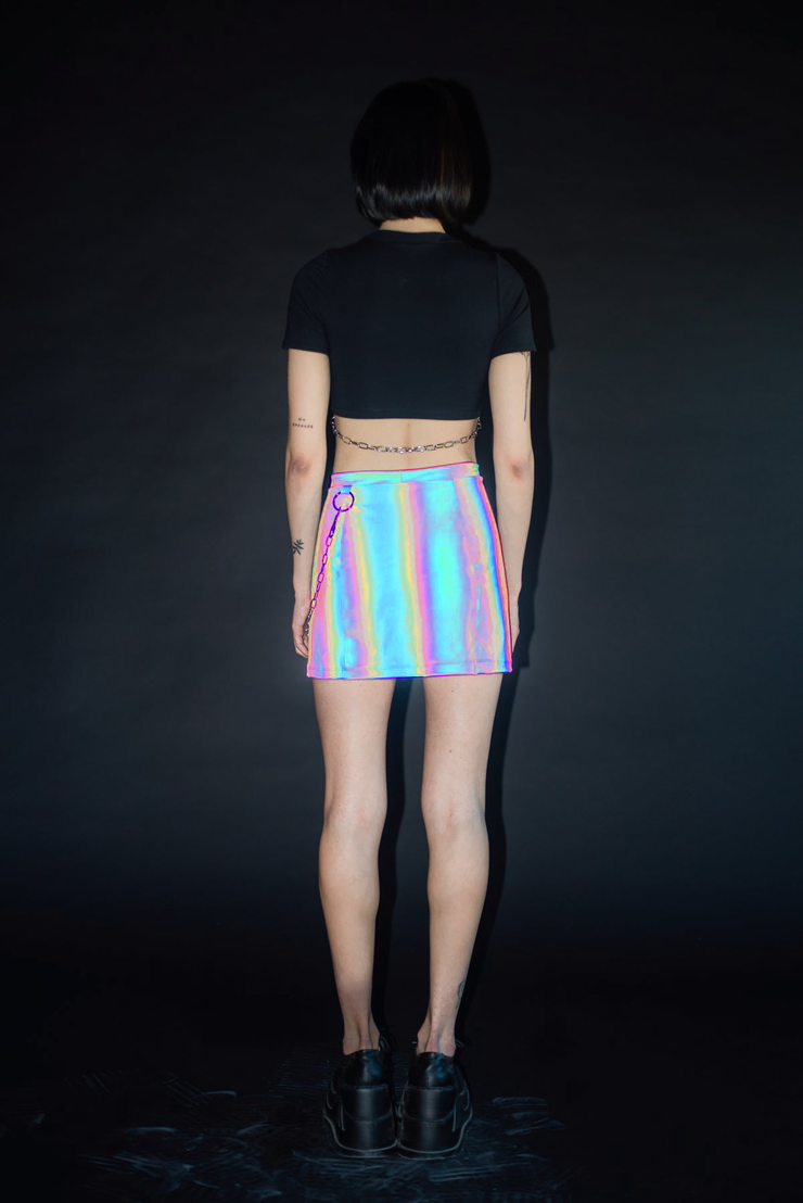 Reflective rainbow mini skirt with silver chain belt.