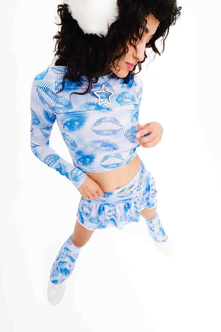 Blue and white mini skirt with a 2000s style print and matching leg warmers.