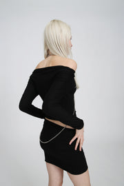 Close-up of black mesh top showing the front ring detail and attached chains, with sheer stretchy fabric texture.