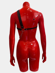 An asymmetric unisex harness crafted from thick black bands and silver chains, designed for a bold and unconventional statement, shown from the back.