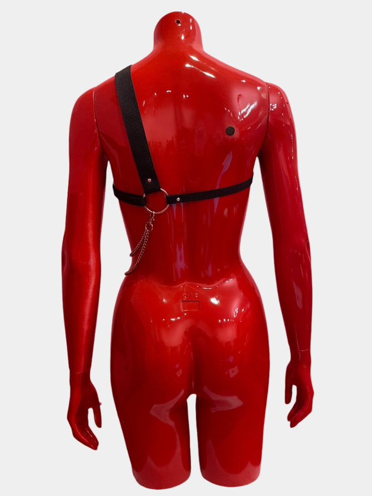 An asymmetric unisex harness crafted from thick black bands and silver chains, designed for a bold and unconventional statement, shown from the back.