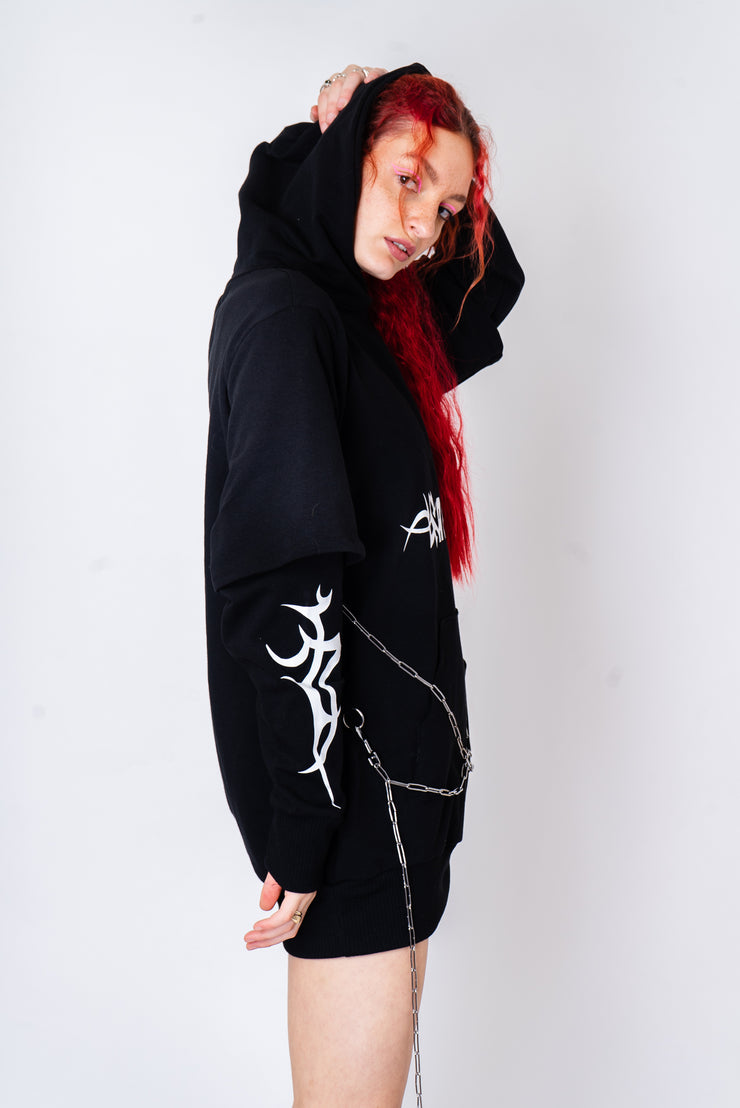 Black oversized hoodie with tribal print and chain detailing.