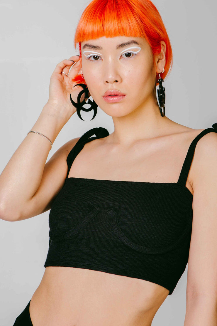 Black statement earrings in a toxic symbol shape.