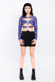 Blue and red lava print top with cutouts and silver ring details.