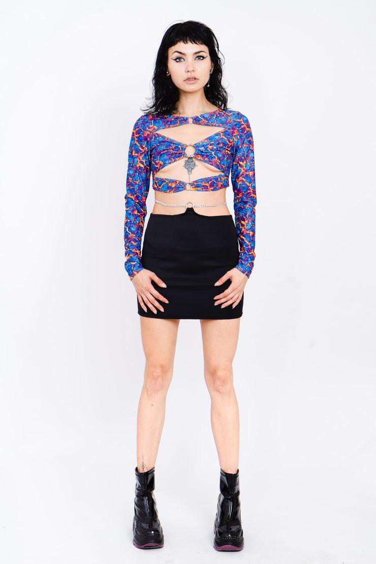 Blue and red lava print top with cutouts and silver ring details.