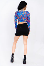 Blue and red lava print top with cutouts and silver ring details.