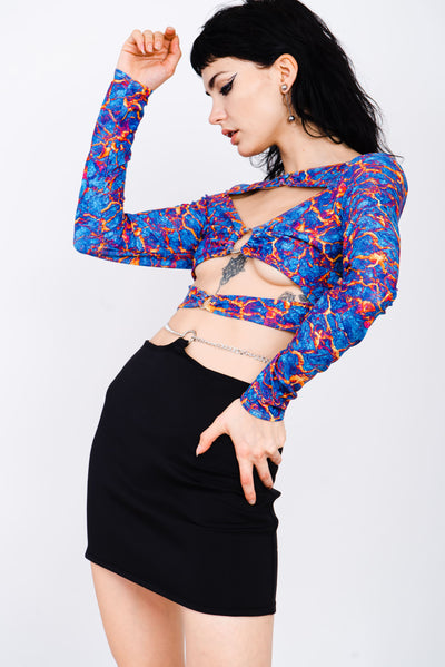 Blue and red lava print top with cutouts and silver ring details.