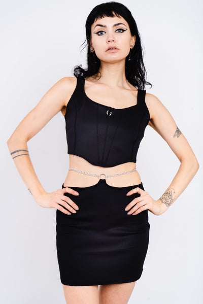 Sleek black corset with silver piercing detail.