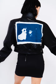 Black vegan leather bomber with blue and white print on back.