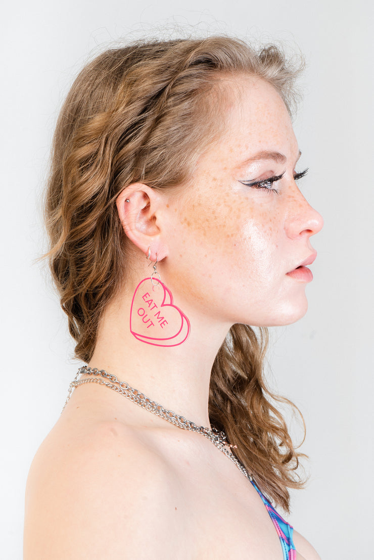 Clear pink PVC earrings in the shape of candy hearts.