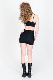 Black asymmetrical crop top with lots of cutouts. 