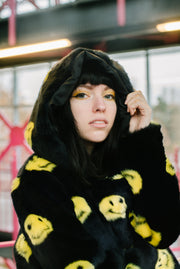 black jacket with yellow smiley faces and buckles