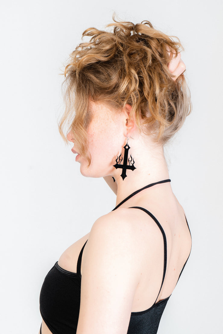 Flaming cross statement earrings in black.