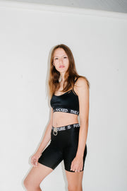 black crop and biker shorts with glitchy text and O ring accent at waist