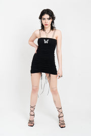 Black gathered mini dress with white butterfly applique.