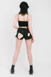 Bleached black mini shorts with gathers on the sides.