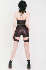 Layered strappy shorts in the "Lara Croft" style made out of purple snake print fabric from the back