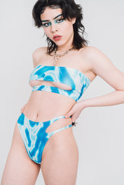 Blue and white bathing suit bottoms with cutout on the side.