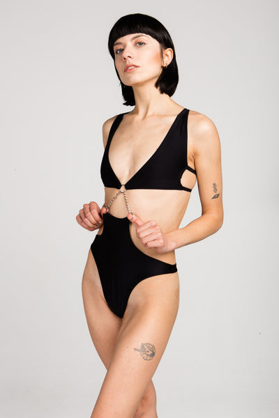 black bodysuit connected by chains