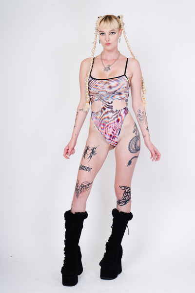 See through mesh layered bodysuit with daring cutouts for festivals.