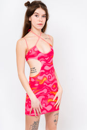Neon pink and orange dress with strappy detail and cutouts.