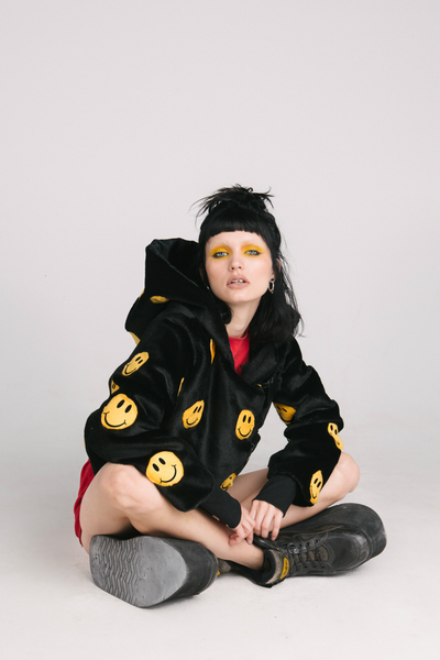 black jacket with yellow smiley faces and buckles