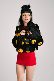 black jacket with yellow smiley faces and buckles