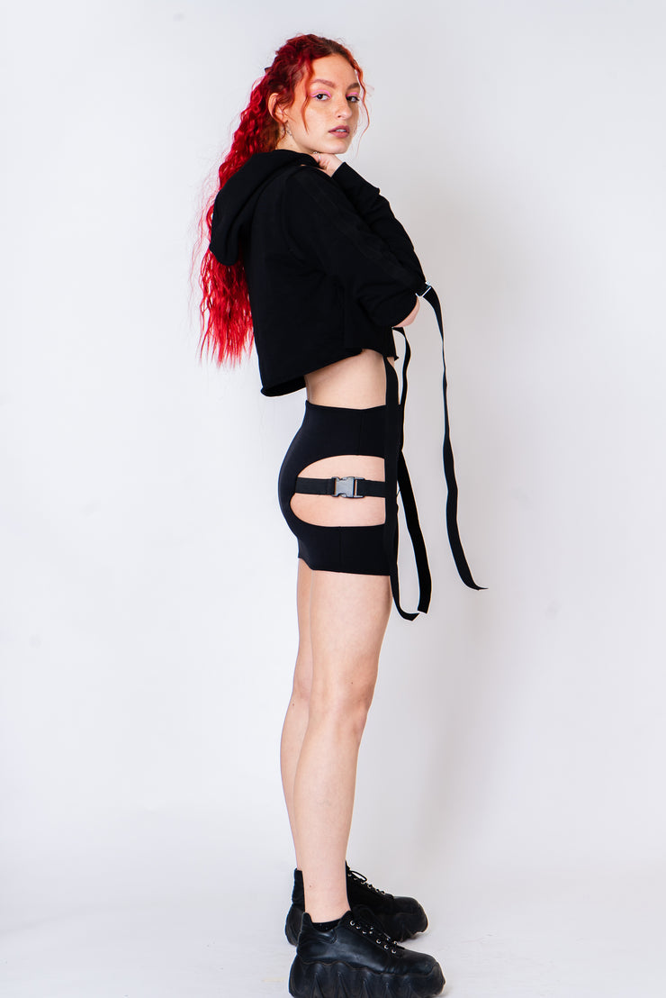 Black strappy hoodie with cutouts and silver hardware.