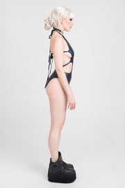 Black holographic bathing or bodysuit with strappy detailing.