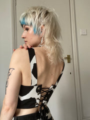 Black and white cow print corset with padlock detail.