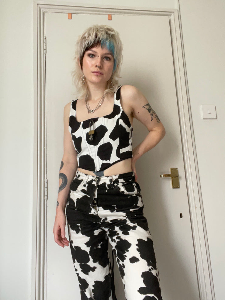 Black and white cow print corset with padlock detail.