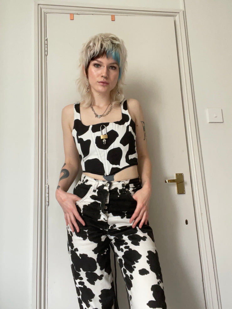 Black and white cow print corset with padlock detail.